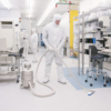 cleanroom with man in bunny suit and vacuum cleaner