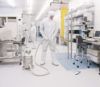 cleanroom with man in bunny suit and vacuum cleaner