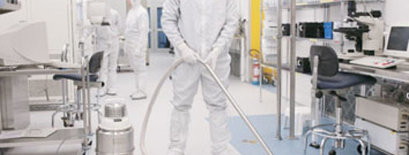 cleanroom with man in bunny suit and vacuum cleaner